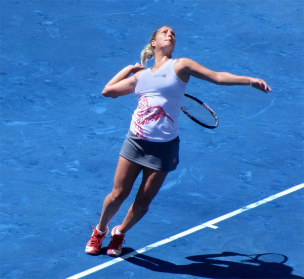 Tennis player swinging a racquet — elbow pain treatment